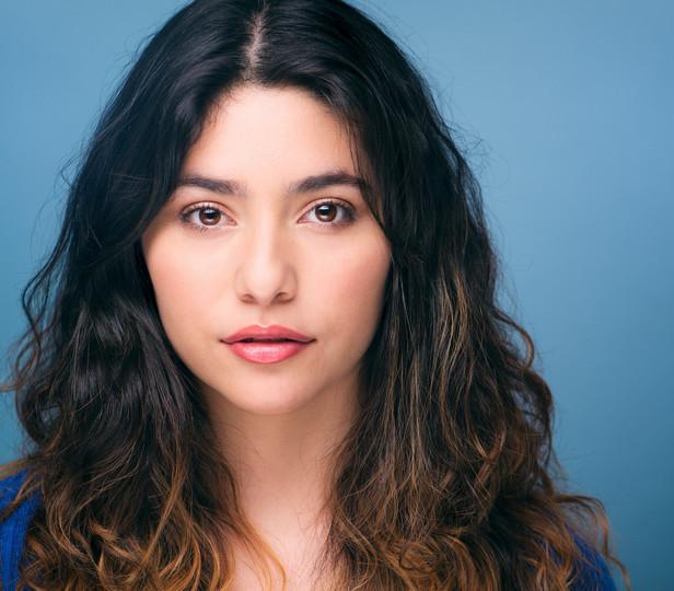 Headshot of Gabriela Torres against a blue background